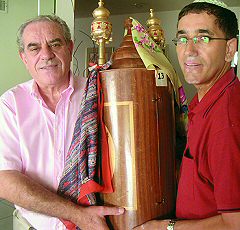 Avi Dahan, left, and Nisim Dadon, two founders of the Scottsdale Sepharadic Synagogue, hold a Torah that was originally dedicated by Dahan's grandmother at a Jerusalem synagogue.